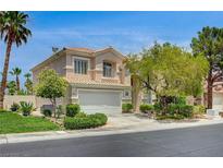 Two-story home showcasing desert landscaping, a well-maintained lawn and a two-car garage at 301 Lakewood Garden Dr, Las Vegas, NV 89148