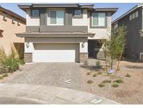 Two-story home featuring a neutral color scheme with a two car garage and desert landscaping at 330 Spring Dove Ave, Henderson, NV 89011
