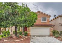 Charming two-story home featuring a well-manicured front yard with a mature shade tree and a two-car garage at 3412 Crystal Tower St, Las Vegas, NV 89129