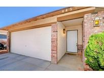 Charming home exterior with a spacious garage, front door entrance, and manicured shrubs at 445 Sam Jonas Dr, Las Vegas, NV 89145