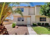 Charming two-story home with a well-maintained front yard featuring desert landscaping and mature palm trees at 4693 Mill Valley Dr, Las Vegas, NV 89120