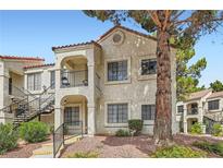 Charming two-story condo with stucco siding, balcony, and mature tree at 4718 Nara Vista Way # 104, Las Vegas, NV 89103