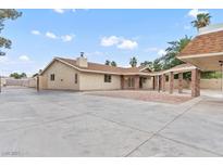 Spacious single-story home featuring a large concrete patio, brick accents, and a welcoming covered area at 4805 Jay Ave, Las Vegas, NV 89130