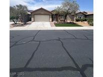 Charming single-story home featuring a well-maintained front yard with trees and a wide driveway at 6092 Fox Creek Ave, Las Vegas, NV 89122