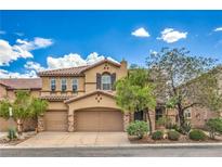 Charming two-story home with a three-car garage, mature landscaping, and a tile roof at 7095 Mountain Den Ave, Las Vegas, NV 89179