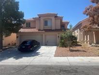 Charming two-story home features a well-manicured front yard and a spacious three-car garage at 9365 Sparkling Waters Ave, Las Vegas, NV 89129