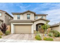 Charming two-story home featuring a two-car garage, stucco exterior, and tiled roof at 9876 Heather Moore Ave, Las Vegas, NV 89166
