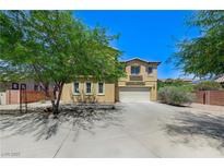 Two-story home featuring a two-car garage, desert landscaping, and mature shade trees at , North Las Vegas, NV 89084