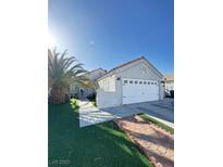 Charming single-story home with desert landscaping, a spacious driveway, and a two-car garage at 1505 Lilac Breeze Cir, Las Vegas, NV 89108