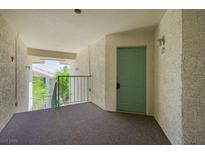 Condo entrance featuring a light green door with unit number, and view of trees from the hall at 3550 Bay Sands Dr # 3006, Laughlin, NV 89029