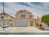 Charming two-story home featuring a two-car garage and neutral stucco finish with a lovely red tile roof at 420 Clifton Heights Dr, Las Vegas, NV 89145