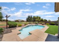 Backyard pool with tanning deck, green grass, and mountain views in a desert landscape at 5586 Golden Leaf Ave, Las Vegas, NV 89122