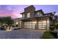 Stunning two-story home with a modern design, desert landscaping, and two-car garage at 6338 Skystone St, Las Vegas, NV 89135