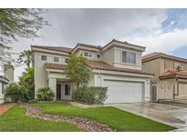 Charming two-story home with a well-manicured lawn and a two-car garage with a new roof and green grass at 7267 W Mesa Vista Ave, Las Vegas, NV 89113