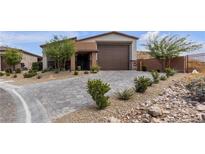 Beautiful single story home with an attached two car garage, lovely landscaping, and a paved driveway at 9570 Thistle Creek Ave, Las Vegas, NV 89178