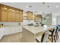 Bright kitchen features a spacious island, pendant lighting, and custom cabinets at 10277 Roma Madre Ave, Las Vegas, NV 89135