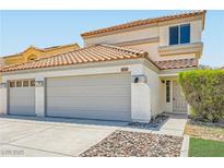 Two-story home featuring a tile roof, a two-car garage, and low-maintenance landscaping at 1501 Lucia Dr, Las Vegas, NV 89128