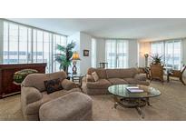 Bright living room featuring comfortable seating, decorative plants, and elegant glass tables at 2877 Paradise Rd # 906, Las Vegas, NV 89109