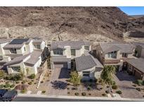 Stunning two-story home in a desert community with a paved driveway and desert landscaping at 30 Hilltop Crest St, Henderson, NV 89011