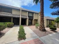 Inviting townhomes with desert landscaping, and a large palm tree at 3278 Liahona Way, Las Vegas, NV 89121