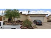 Charming single-story home with a well-kept front yard, driveway and attached garage at 405 Scenic Dr, Henderson, NV 89002