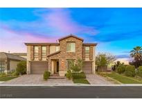 Stunning two-story home featuring stone accents, a three-car garage, and beautiful landscaping at 4702 Amazing View St, Las Vegas, NV 89129