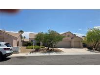 Charming single-story home featuring a two-car garage and desert landscaping in front at 6113 Desert Haven Rd, Las Vegas, NV 89130