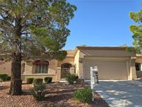 Charming single-story home featuring a well-manicured front yard and attached two-car garage at 9329 Fresh Spring Dr, Las Vegas, NV 89134