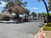Community entrance gate with black iron details and lush landscaping creating an inviting atmosphere at 1667 Marion Bennet Dr, Las Vegas, NV 89106