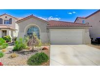Charming single-story home features a two-car garage, desert landscaping, and a red tile roof at 1829 Fighting Falcon Ln, North Las Vegas, NV 89031
