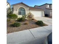 Charming single-story home featuring a well-maintained front yard with low maintenance landscaping at 1829 Fighting Falcon Ln, North Las Vegas, NV 89031