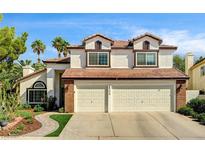 Charming two-story home with a well-manicured lawn and a spacious two-car garage at 2036 Deer Springs Dr, Henderson, NV 89074