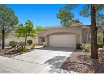 Charming single-story home with a two-car garage, well-manicured landscaping, and a spacious driveway at 2216 Spring Water Dr, Las Vegas, NV 89134