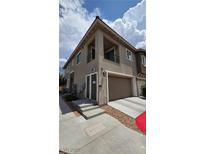 Two story home with a two-car garage, a small balcony, and neutral-tone paint at 25 Barbara Ln # 8, Las Vegas, NV 89183