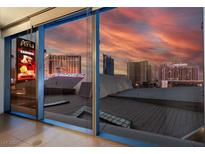 Expansive city view through large window showcases Aria, Hollywood, and Polo Towers set against a vibrant sunset at 3722 S Las Vegas Blvd # 503, Las Vegas, NV 89158