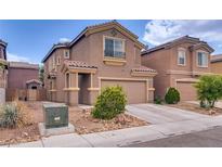 Charming two-story home with a two-car garage and desert landscaping at 4609 Hearts Desire Ave, Las Vegas, NV 89115