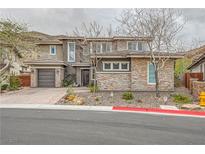 Beautiful two-story home featuring stone accents, a two-car garage and meticulously landscaped front yard at 5879 Sky Heights Ct, Las Vegas, NV 89135