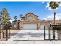 Charming two-story home featuring a three-car garage, desert landscaping, and a gated entrance at 6101 Browning Way, Las Vegas, NV 89130