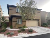 Charming two-story home featuring a neutral color scheme, a two-car garage and well-manicured landscaping at 10537 Thor Mountain Ln, Las Vegas, NV 89166
