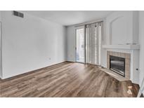 Living room with a fireplace, wood flooring and a sliding door to the outside at 1300 S Arlington St # 120, Las Vegas, NV 89104