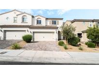 Charming townhome features a neutral color palette, brick driveway and a two-car garage at 285 Rain Quail Way, Henderson, NV 89012