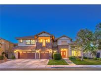Elegant two-story home featuring a three-car garage, brick accents, and well-manicured landscaping at 2982 Hammerwood Dr, Las Vegas, NV 89135