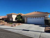 Charming single-story home featuring a tile roof, two-car garage, desert landscaping, and a well-maintained lawn at 3012 Hawksdale Dr, Las Vegas, NV 89134