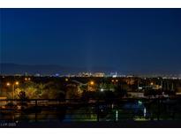 Night skyline view features the illuminated buildings of Las Vegas and tree-lined streets at 3980 Heron Fairway Dr, Las Vegas, NV 89141