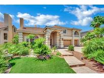 Gorgeous two-story home with lush landscaping and a charming entrance in a desirable Las Vegas community at 4139 Abernethy Forest Pl, Las Vegas, NV 89141