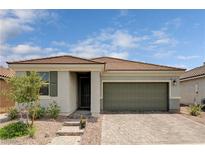 Charming single-story home with a two-car garage and a beautifully landscaped front yard at 4293 Nopal Serrano Ave, Las Vegas, NV 89141