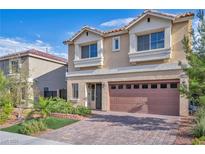 Charming two-story home featuring a two-car garage, well-maintained landscaping, and brick-paved driveway at 5341 Kennedy Hill Ave, Las Vegas, NV 89139