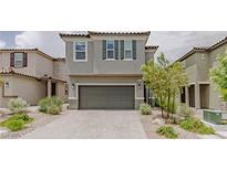 Charming two-story home boasts a neutral color, two-car garage, and low-maintenance landscaping at 5927 Coja St, Las Vegas, NV 89113