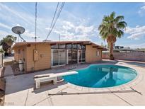 Mid-century home backyard featuring a diving board over a sparkling blue kidney-shaped pool at 6112 Fairwood Cir, Las Vegas, NV 89107
