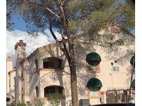 Charming exterior of a multi-unit home featuring desert landscaping and a private balcony at 7570 W Flamingo Rd # 202, Las Vegas, NV 89147